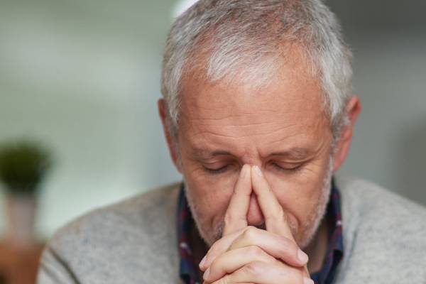 ent - nose A man resting his face on his steepled fingers