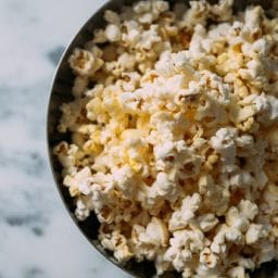 A bowl of popcorn on a table.