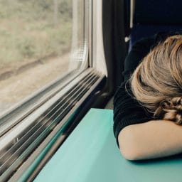 Woman falls asleep on a train.