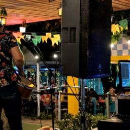 A musician playing a show next to a listening monitor.