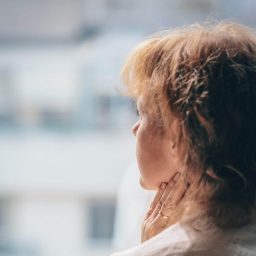 Woman feeling her thyroid.