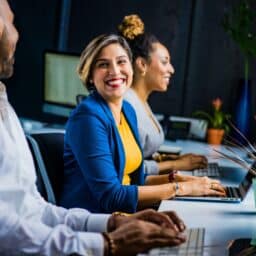Woman at work chatting with her coworkers.