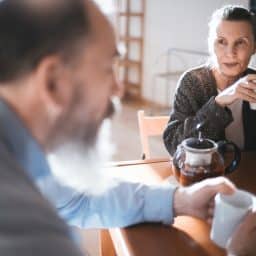 Husband and wife having coffee together at home in the morning.
