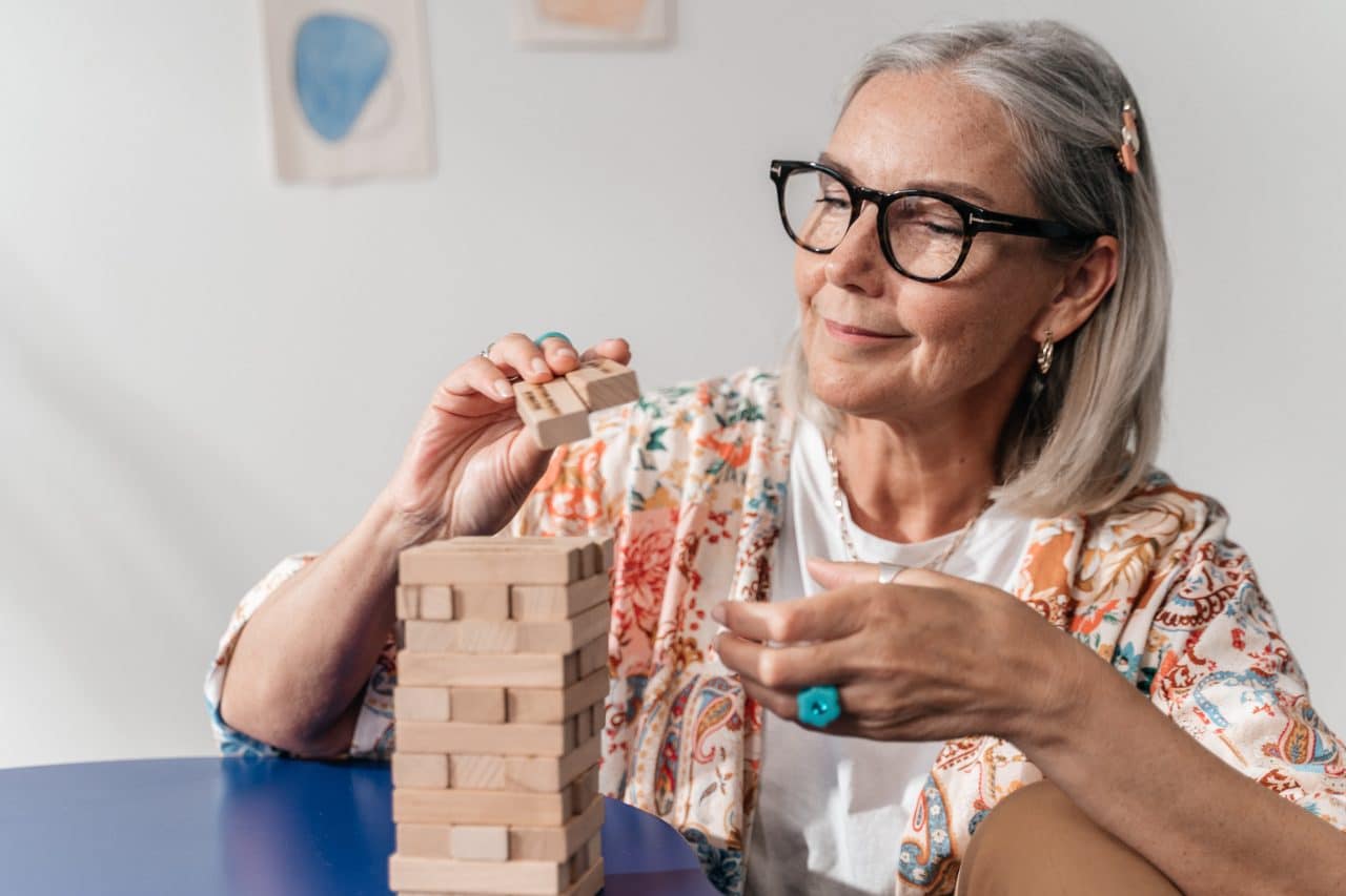 Senior woman putting together a puzzle.
