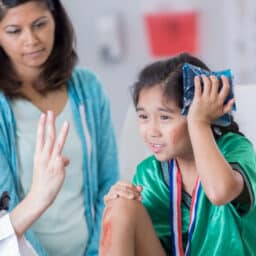 Young girl seeing a doctor after hitting her head