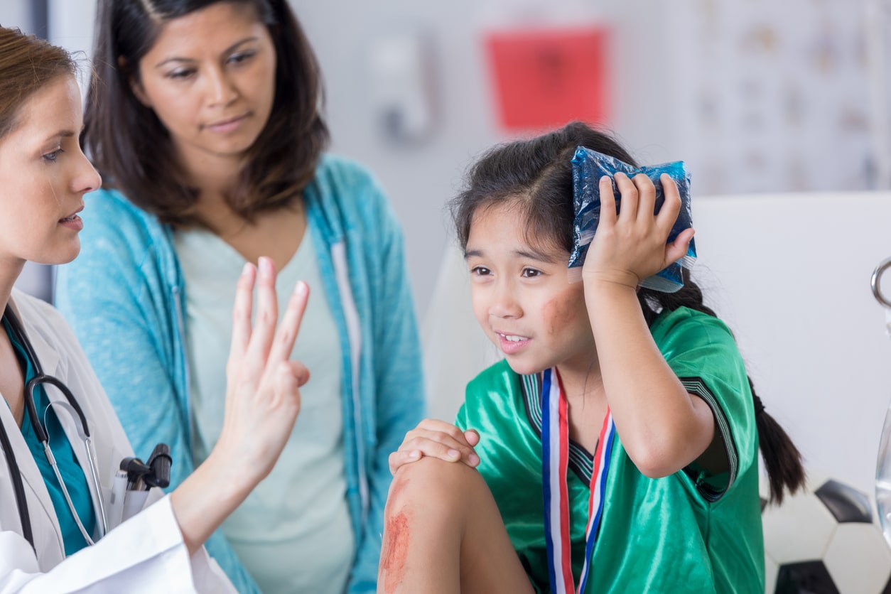 Young girl seeing a doctor after hitting her head.