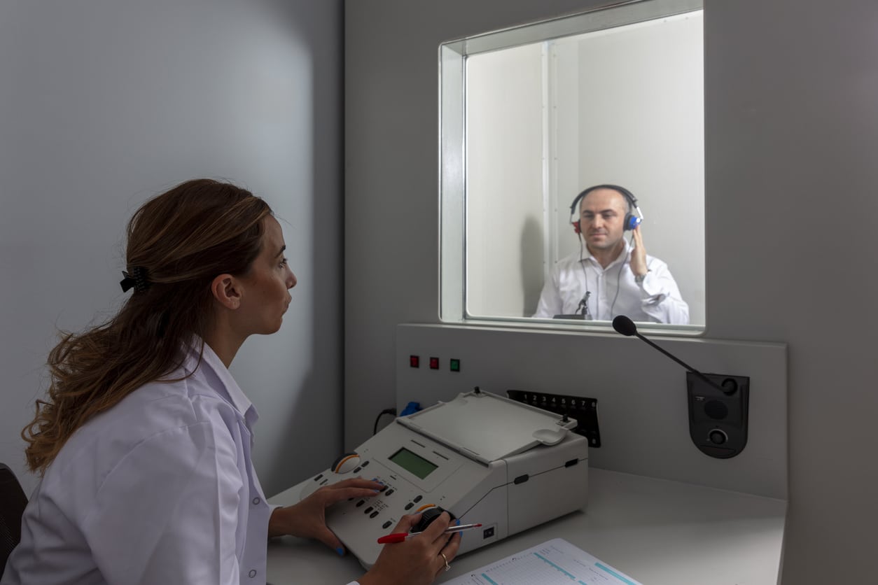 Audiologist administering a hearing test.