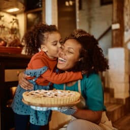 Happy mother and daughter with a holiday pie.