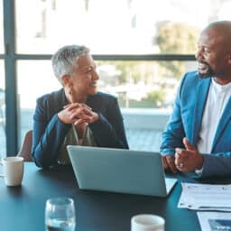 Two business leaders chat together