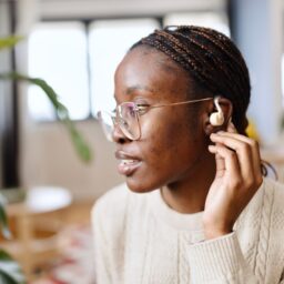 Young adult woman wearing a hearing aid
