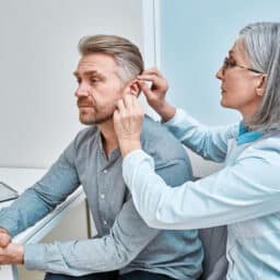 Man is fitted for hearing aids