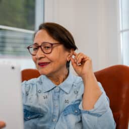 Woman touches ear while talking on phone