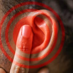 Red Circle On Man's Ear, Tinnitus Concept