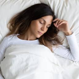 Young woman sleeping in bed