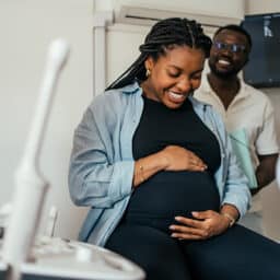 Pregnant woman and her partner at her doctor's appointment.