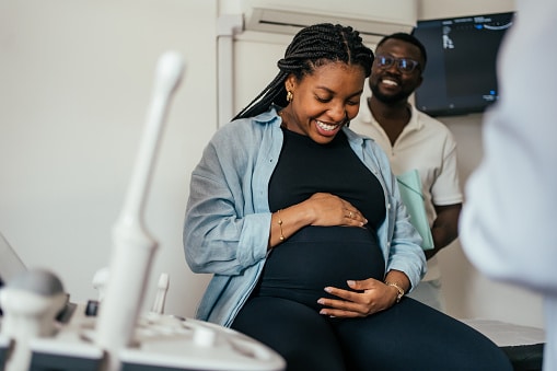 Pregnant woman and her partner at her doctor's appointment.